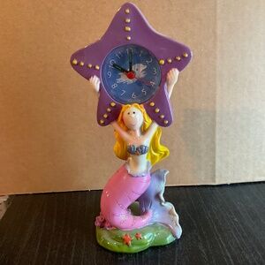 Ceramic mermaid holding clock.  K147